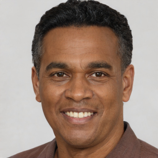 Joyful latino adult male with short  black hair and brown eyes