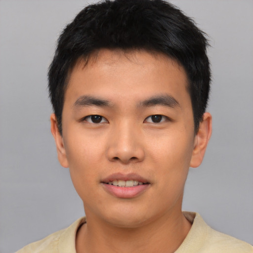 Joyful asian young-adult male with short  brown hair and brown eyes