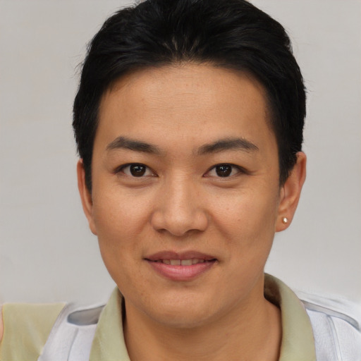 Joyful asian young-adult male with short  brown hair and brown eyes