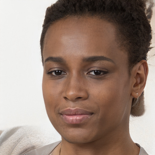 Joyful black young-adult female with short  brown hair and brown eyes