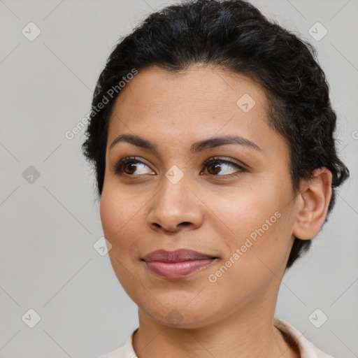 Joyful latino young-adult female with short  brown hair and brown eyes