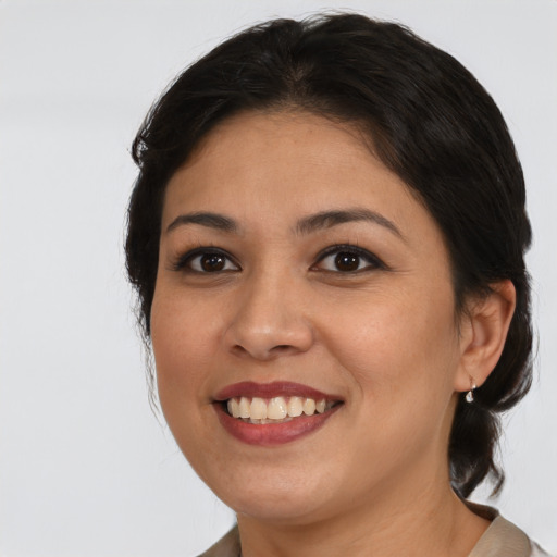 Joyful asian young-adult female with medium  brown hair and brown eyes