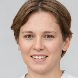 Joyful white young-adult female with short  brown hair and grey eyes