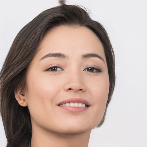 Joyful asian young-adult female with long  brown hair and brown eyes