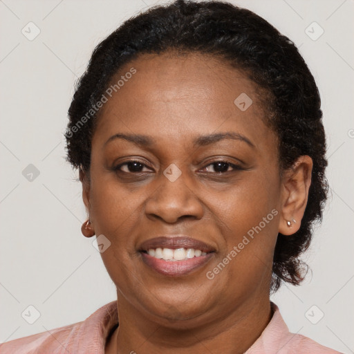 Joyful black adult female with short  brown hair and brown eyes