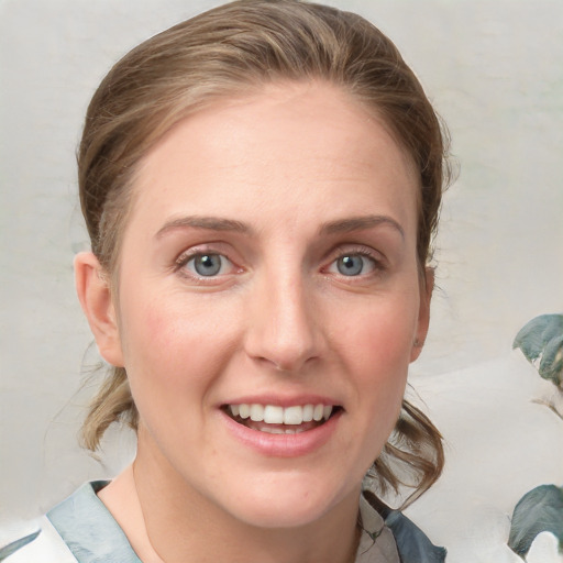 Joyful white young-adult female with medium  brown hair and blue eyes