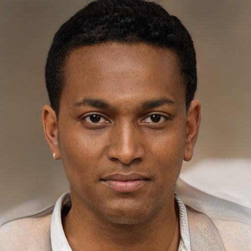 Joyful black young-adult male with short  brown hair and brown eyes