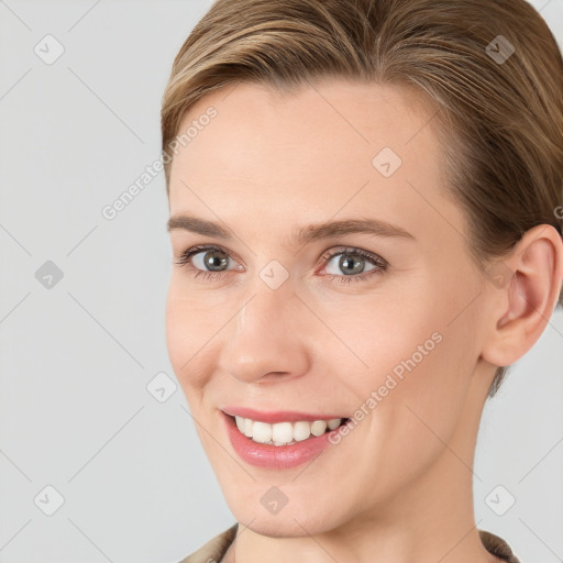 Joyful white young-adult female with short  brown hair and grey eyes