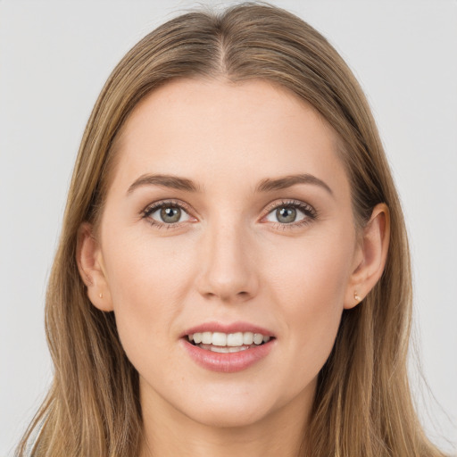 Joyful white young-adult female with long  brown hair and grey eyes