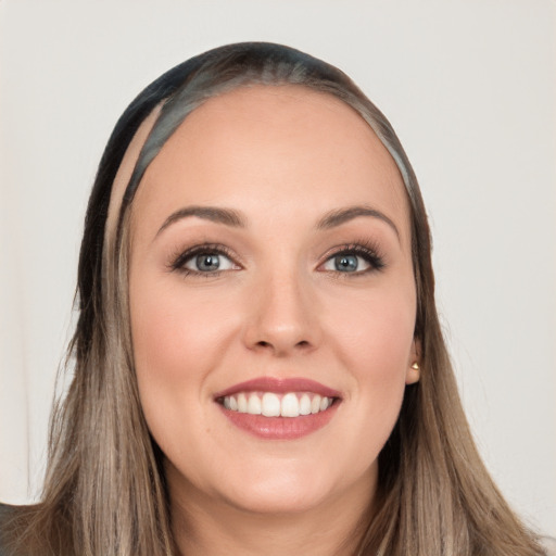 Joyful white young-adult female with long  brown hair and brown eyes