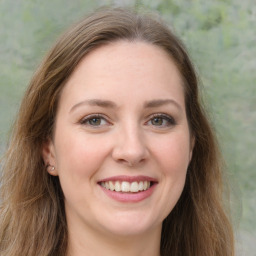 Joyful white young-adult female with long  brown hair and green eyes