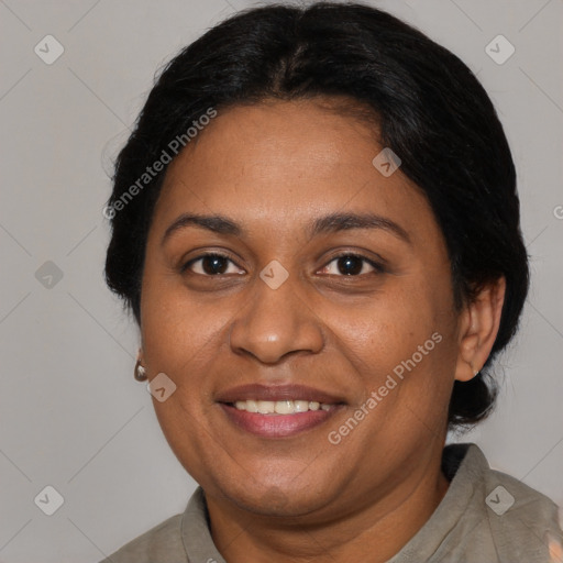 Joyful black adult female with short  brown hair and brown eyes