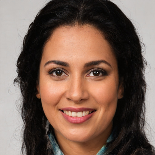 Joyful latino young-adult female with long  brown hair and brown eyes