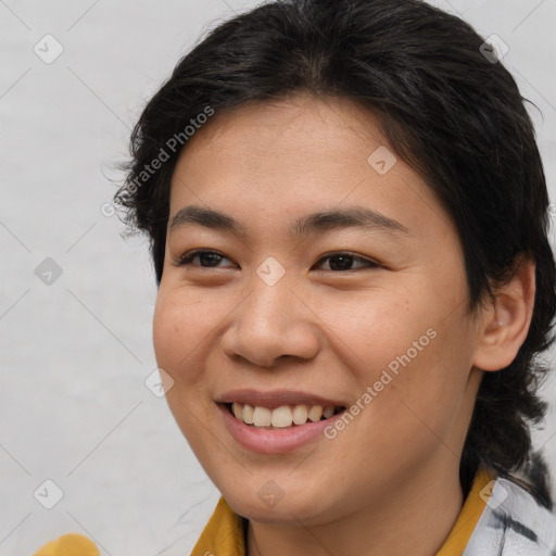 Joyful asian young-adult female with medium  brown hair and brown eyes