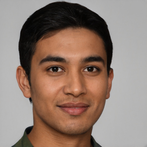 Joyful latino young-adult male with short  black hair and brown eyes