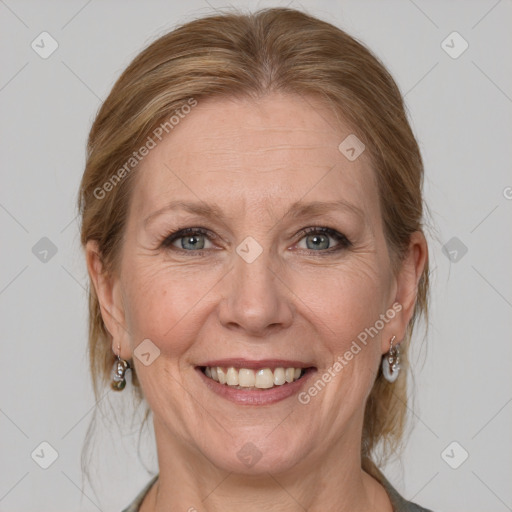 Joyful white adult female with medium  brown hair and grey eyes