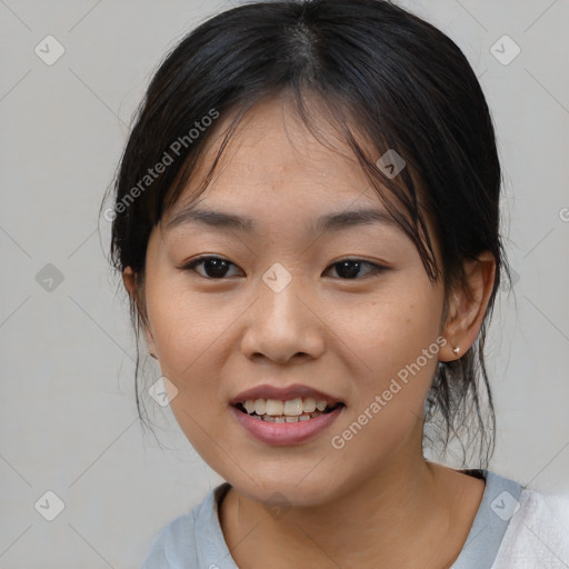 Joyful asian young-adult female with medium  black hair and brown eyes