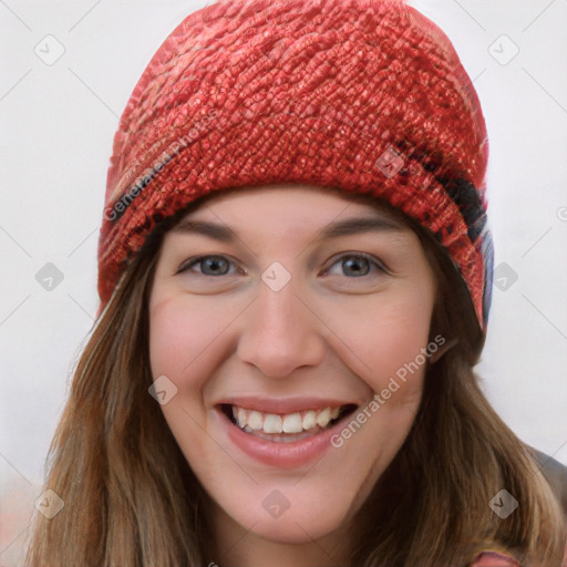 Joyful white young-adult female with long  brown hair and blue eyes