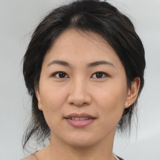 Joyful asian young-adult female with medium  brown hair and brown eyes
