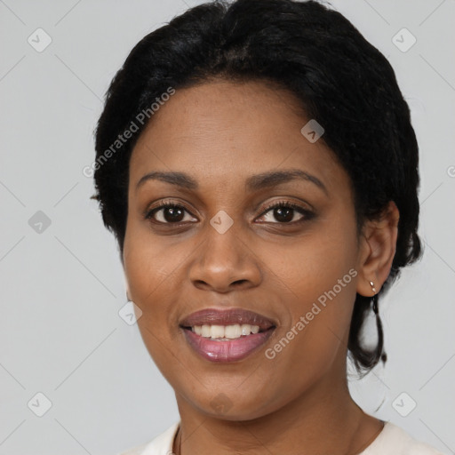 Joyful black young-adult female with short  black hair and brown eyes