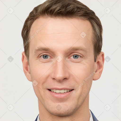 Joyful white young-adult male with short  brown hair and grey eyes