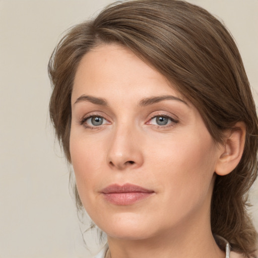 Joyful white young-adult female with medium  brown hair and green eyes