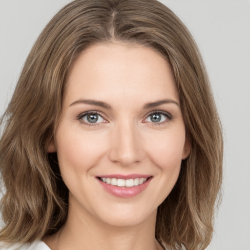 Joyful white young-adult female with medium  brown hair and green eyes