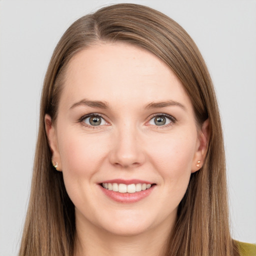 Joyful white young-adult female with long  brown hair and grey eyes