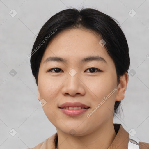 Joyful asian young-adult female with short  black hair and brown eyes