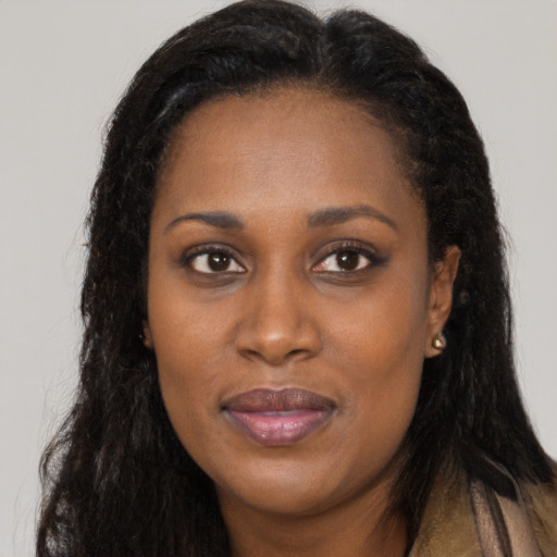 Joyful black young-adult female with long  black hair and brown eyes