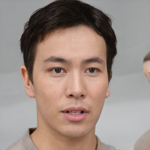 Neutral asian young-adult male with short  brown hair and brown eyes