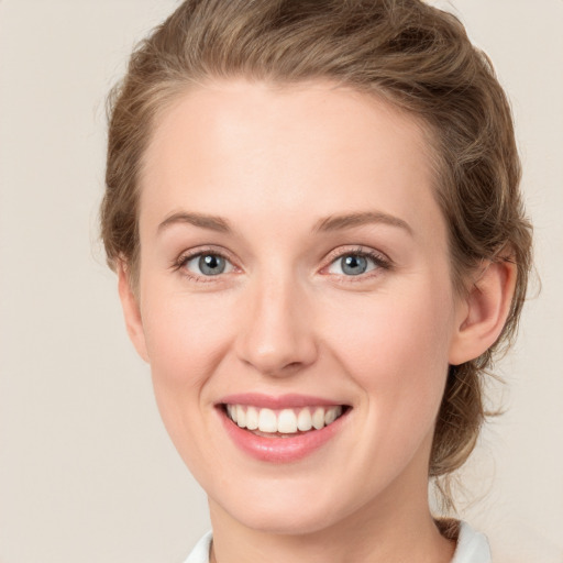 Joyful white young-adult female with medium  brown hair and green eyes