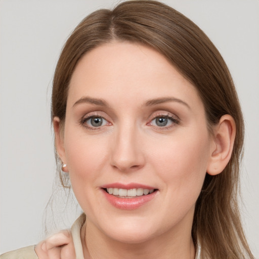 Joyful white young-adult female with medium  brown hair and grey eyes