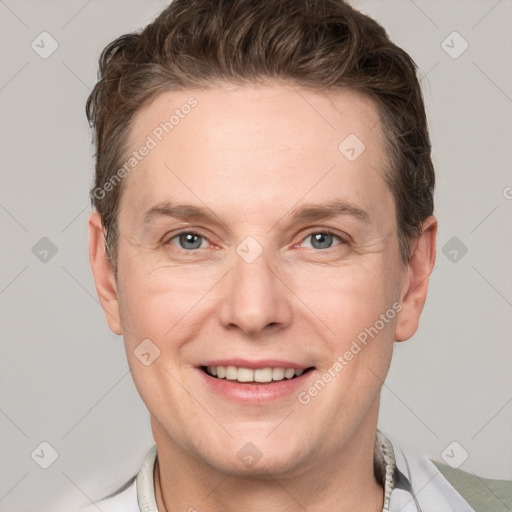 Joyful white adult male with short  brown hair and grey eyes