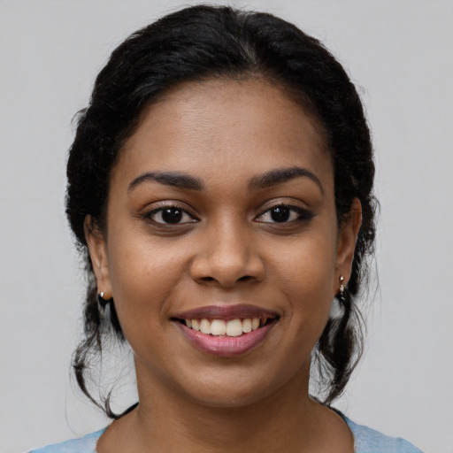Joyful latino young-adult female with long  black hair and brown eyes