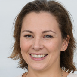 Joyful white adult female with medium  brown hair and brown eyes