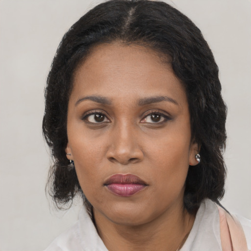 Joyful black young-adult female with medium  brown hair and brown eyes