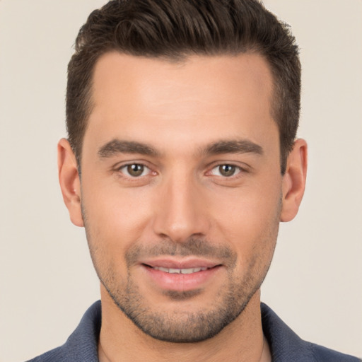 Joyful white young-adult male with short  brown hair and brown eyes