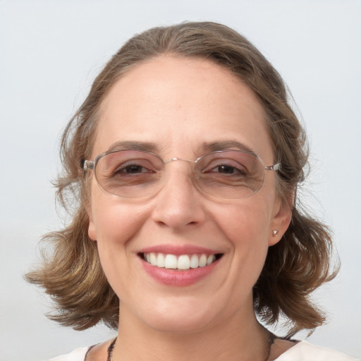 Joyful white adult female with medium  brown hair and blue eyes