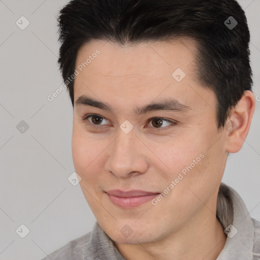 Joyful asian young-adult male with short  brown hair and brown eyes