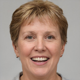 Joyful white adult female with short  brown hair and grey eyes