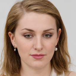 Joyful white young-adult female with long  brown hair and blue eyes