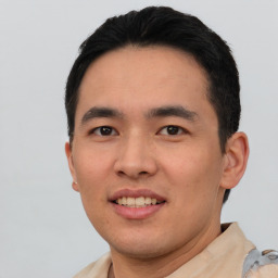 Joyful asian young-adult male with short  black hair and brown eyes