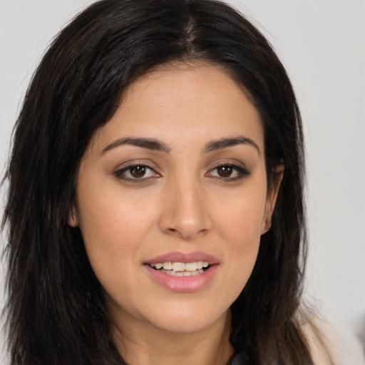 Joyful white young-adult female with long  brown hair and brown eyes