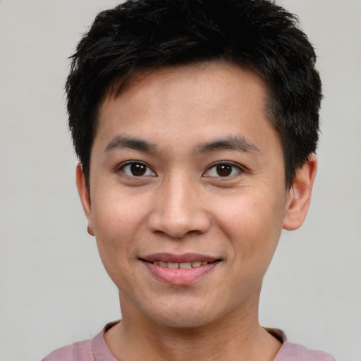 Joyful white young-adult male with short  black hair and brown eyes