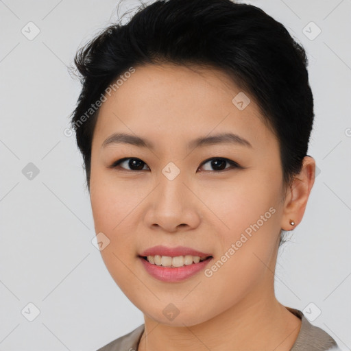 Joyful asian young-adult female with short  black hair and brown eyes