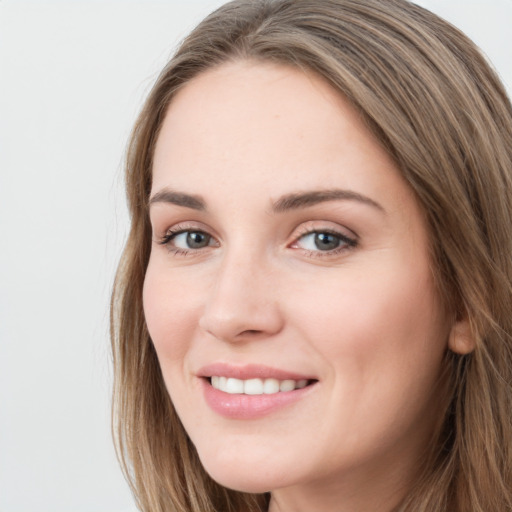 Joyful white young-adult female with long  brown hair and grey eyes