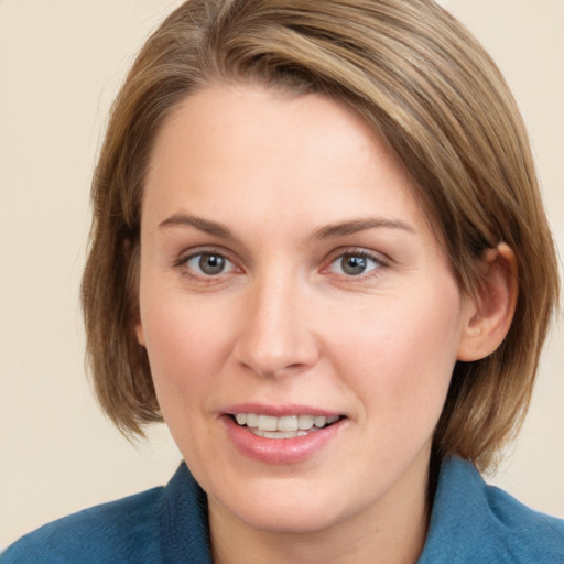 Joyful white young-adult female with medium  brown hair and blue eyes