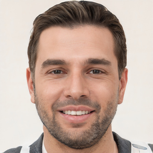 Joyful white young-adult male with short  brown hair and brown eyes