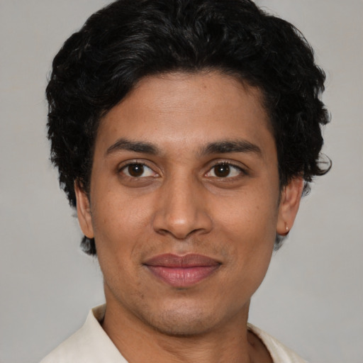 Joyful latino young-adult male with short  brown hair and brown eyes